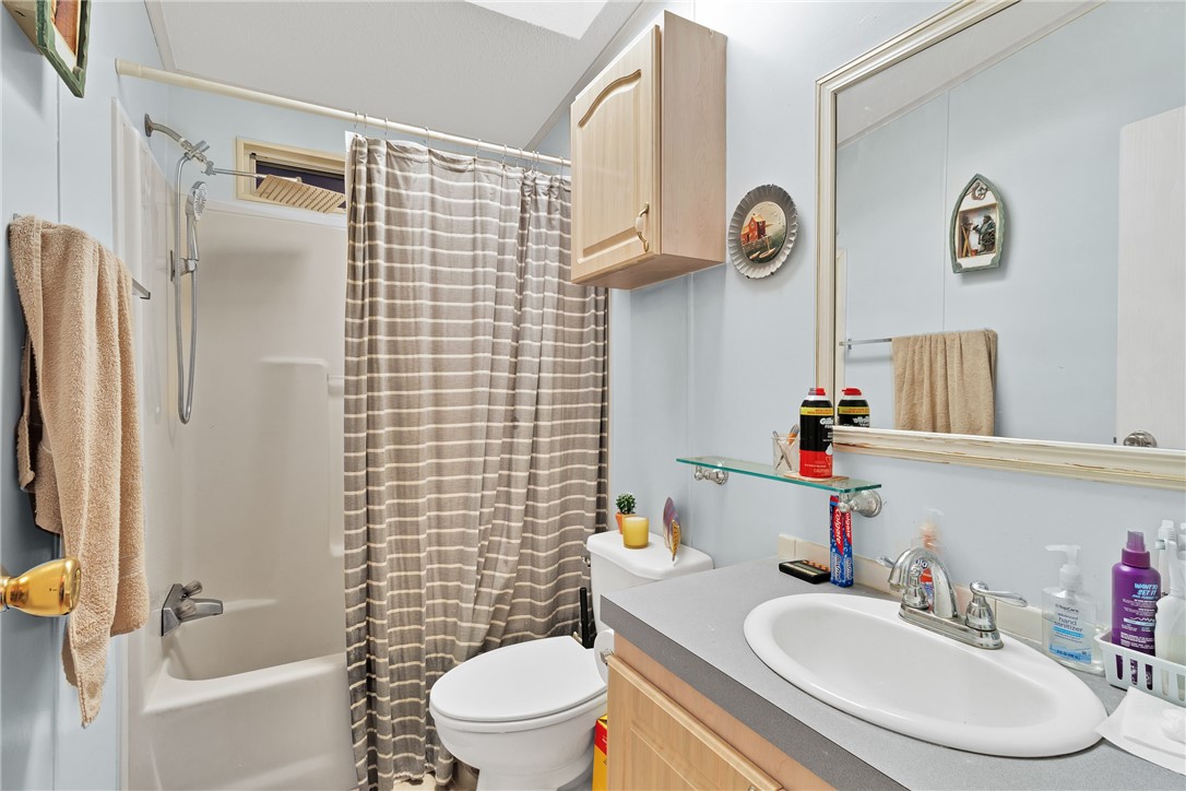 7571 Boxelder Road Micco, FL 32976 - Photo 19 of 36 a bathroom with a sink toilet and shower