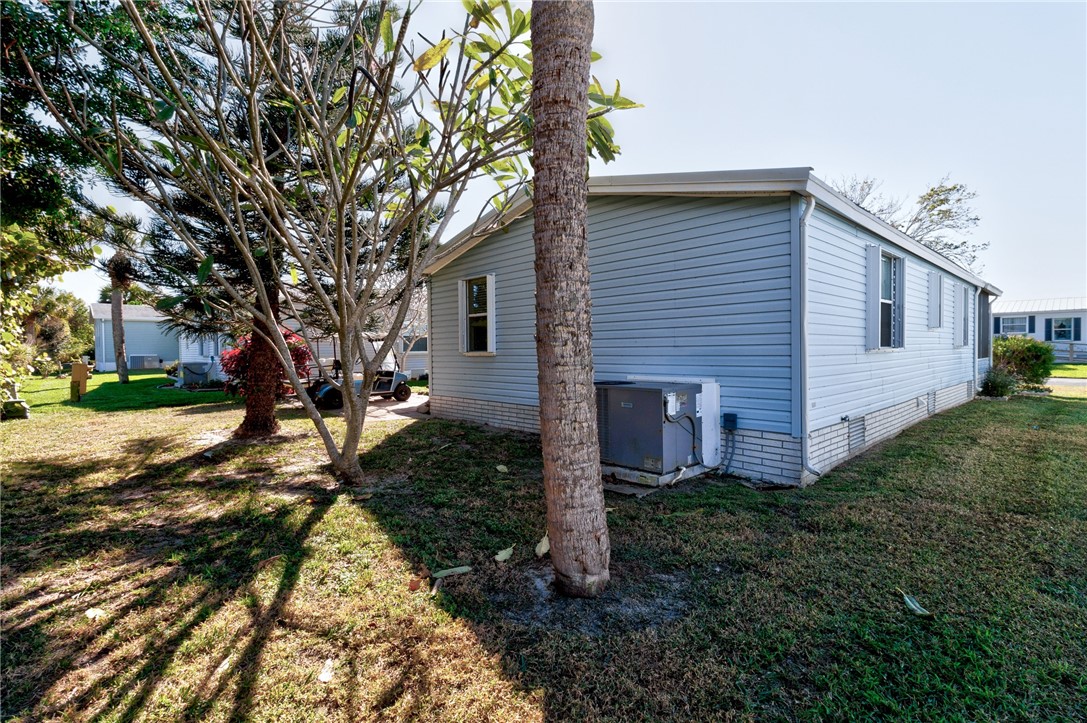 7571 Boxelder Road Micco, FL 32976 - Photo 26 of 36 a front view of a house with garden