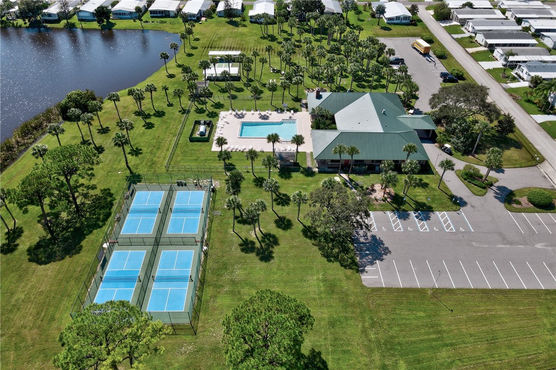7571 Boxelder Road Micco, FL 32976 - Photo 29 of 36 an aerial view of a house with a garden and lake view