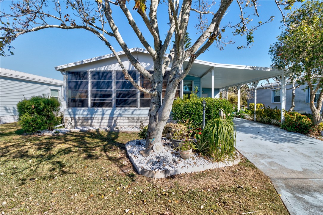 7571 Boxelder Road Micco, FL 32976 - Photo 3 of 36 front view of a house with a tree