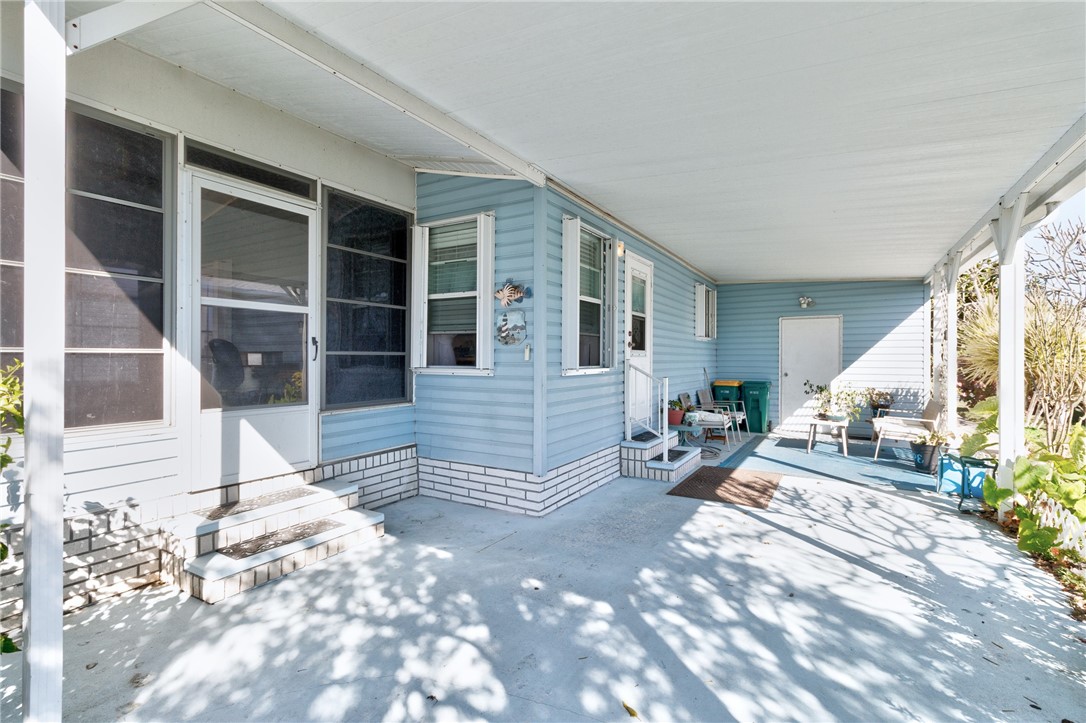 7571 Boxelder Road Micco, FL 32976 - Photo 7 of 36 a view of front door with outdoor seating