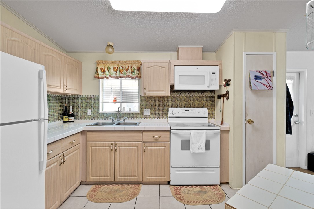 7571 Boxelder Road Micco, FL 32976 - Photo 8 of 36 a kitchen with cabinets and window