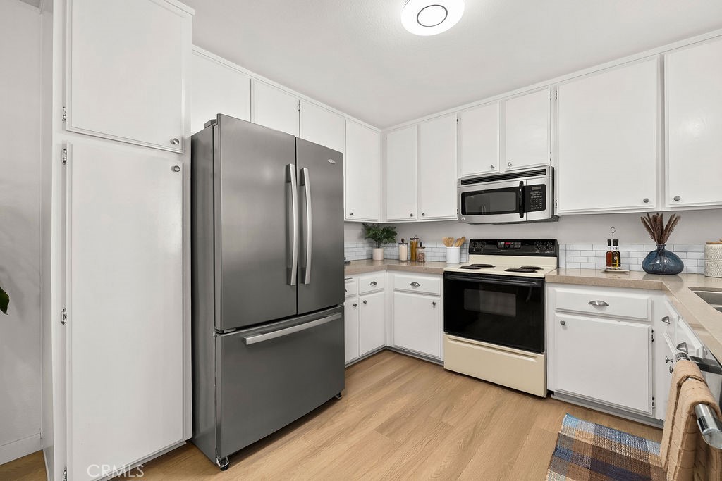 34128 Selva Road, Unit 267 Dana Point, CA 92629 - Photo 16 of 44 a kitchen with stainless steel appliances a refrigerator stove and microwave