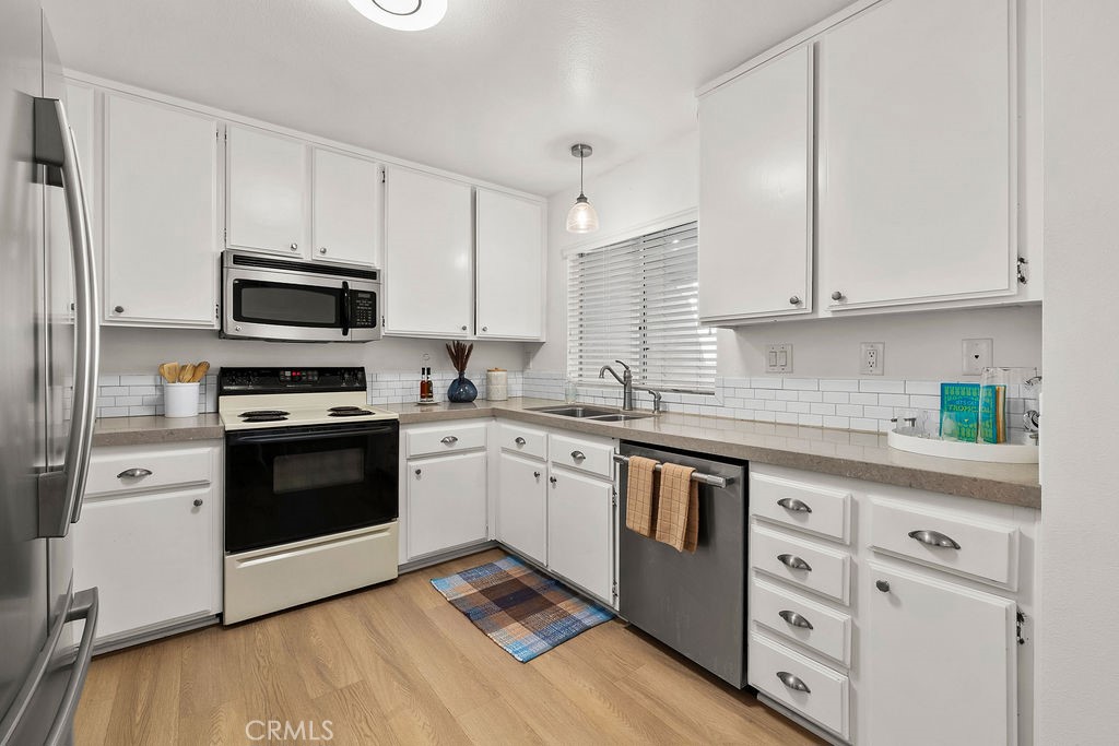 34128 Selva Road, Unit 267 Dana Point, CA 92629 - Photo 19 of 44 a kitchen with granite countertop white cabinets and stainless steel appliances