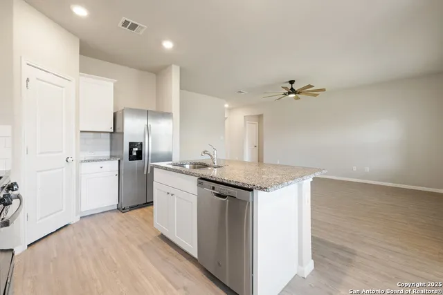 a kitchen with a sink and refrigerator