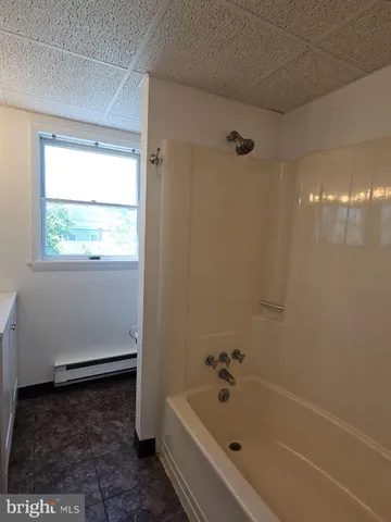 a bathroom with a bathtub and window