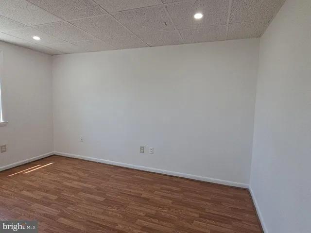 a view of room with wooden floor