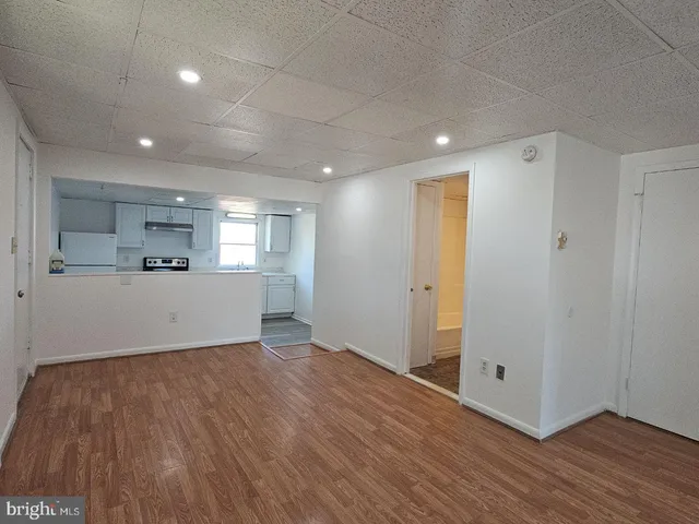 a view of a kitchen with wooden floor and a sink