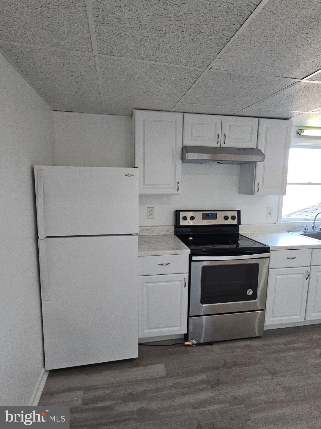 10 East Broad Street, Unit 2 Millville, NJ 08332 - Photo 28 of 33 a kitchen with a refrigerator and a stove top oven