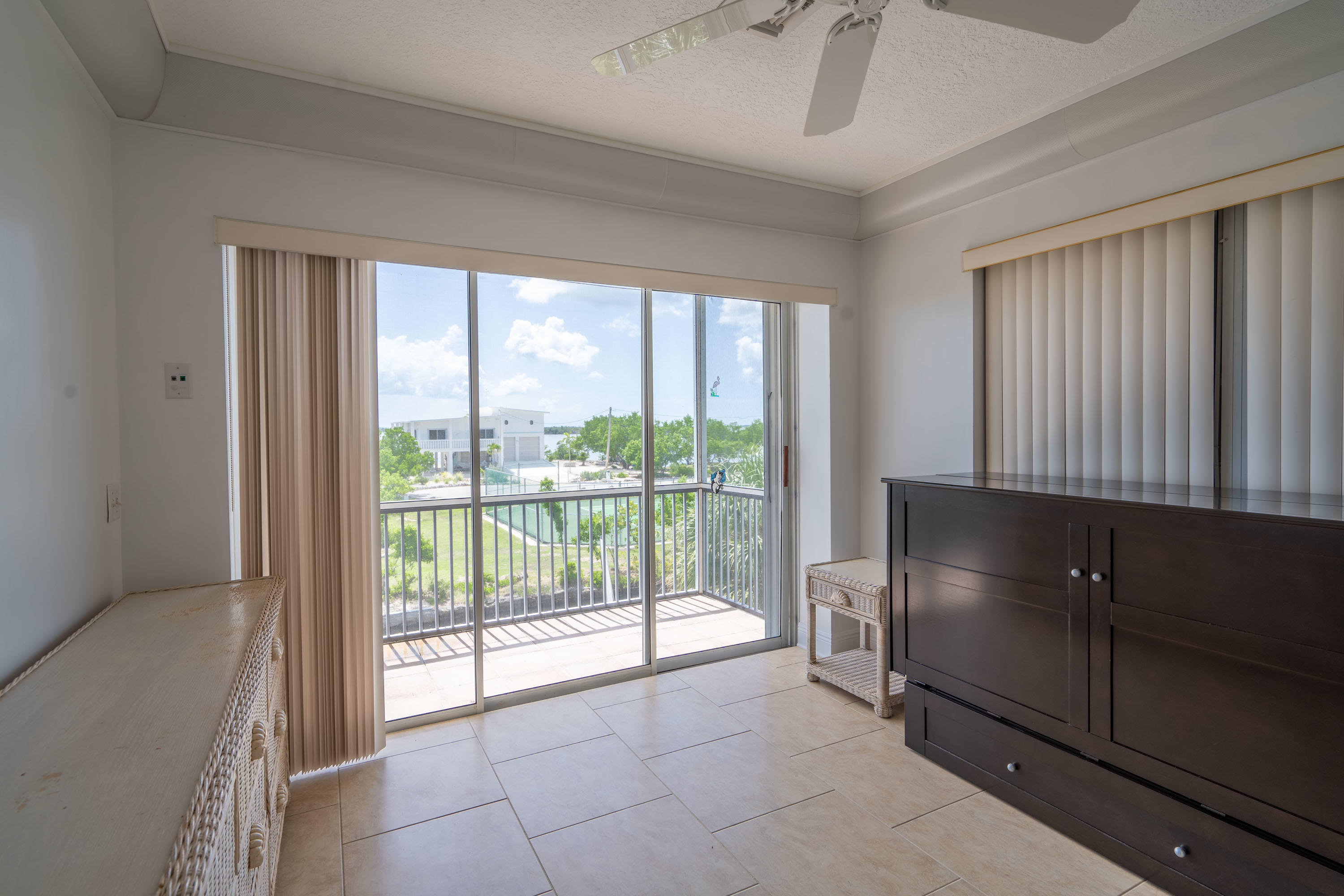 3814 Joyce Road Big Pine Key, FL 33043 - Photo 19 of 40 a view of an empty room with wooden floor and a window
