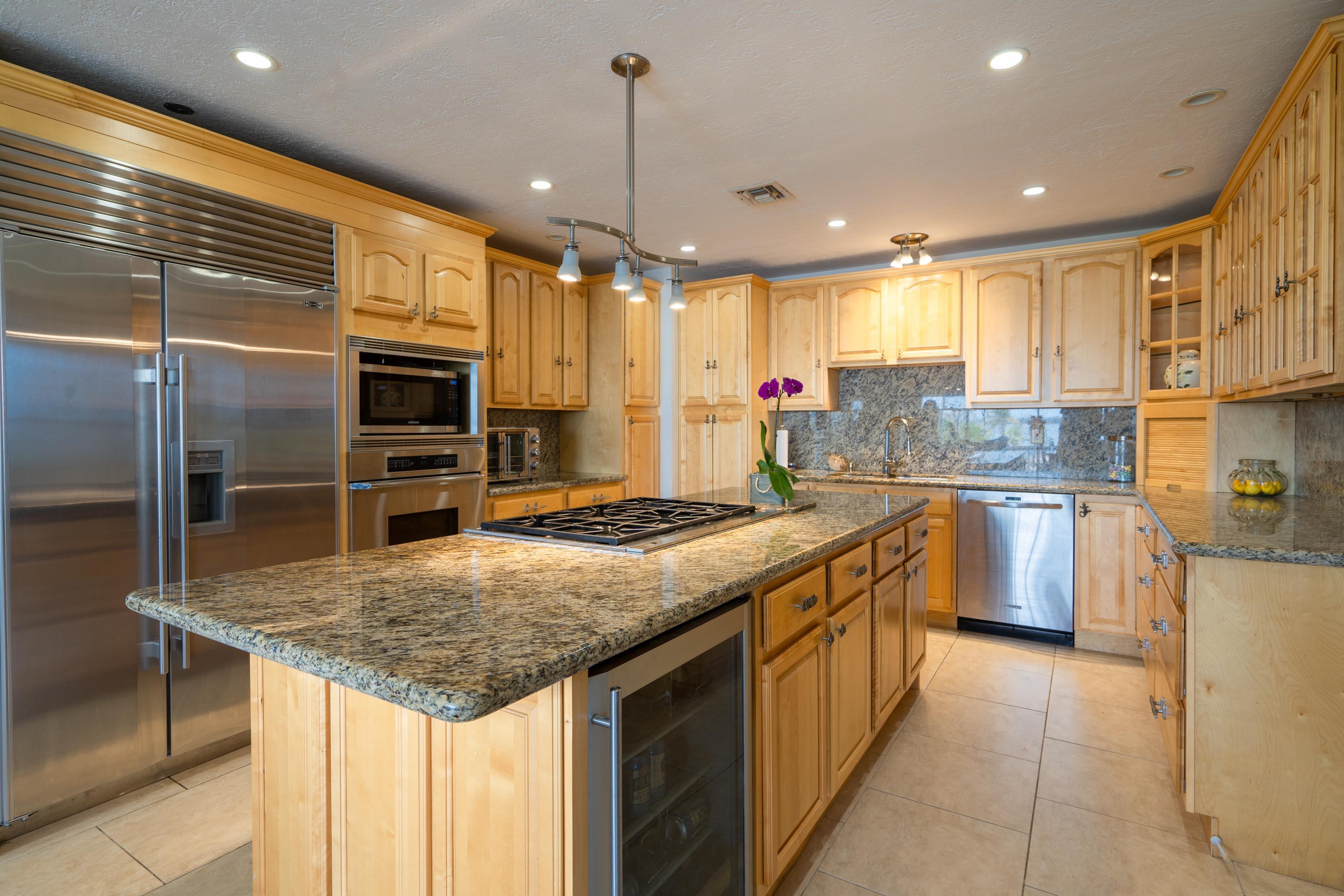 3814 Joyce Road Big Pine Key, FL 33043 - Photo 4 of 40 a kitchen with stainless steel appliances granite countertop a stove top oven a sink and a refrigerator