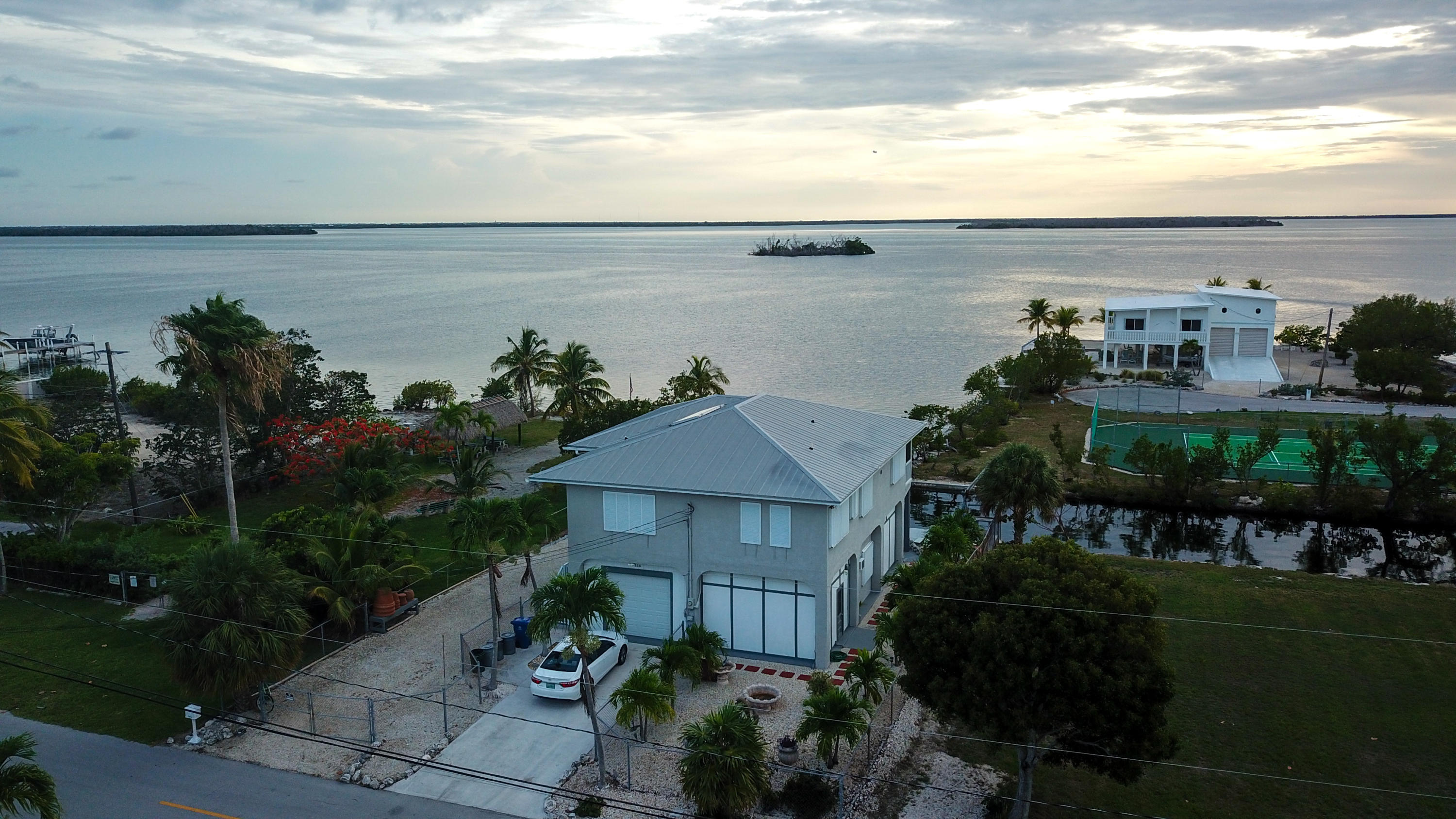 3814 Joyce Road Big Pine Key, FL 33043 - Photo 40 of 40 a view of a house with a yard and potted plants