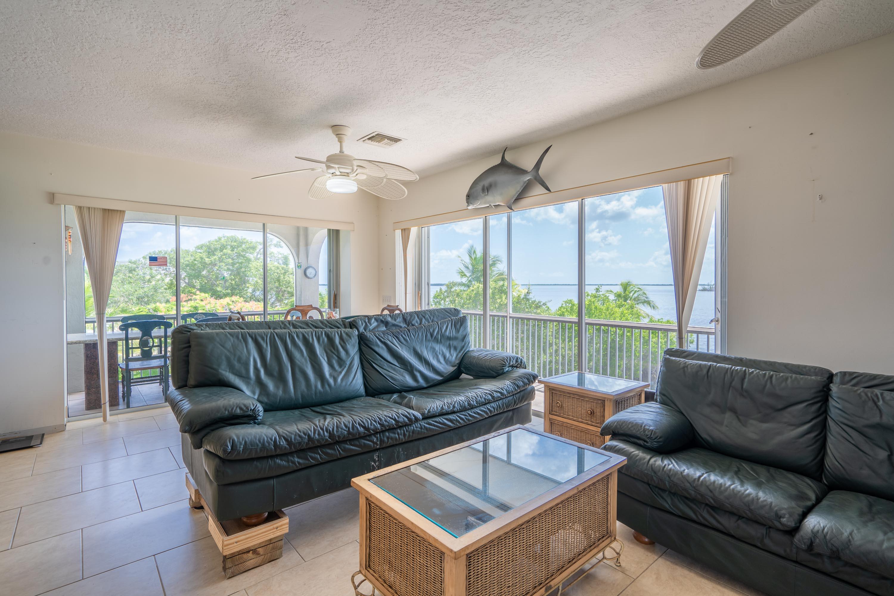 3814 Joyce Road Big Pine Key, FL 33043 - Photo 7 of 40 a living room with furniture and a floor to ceiling window