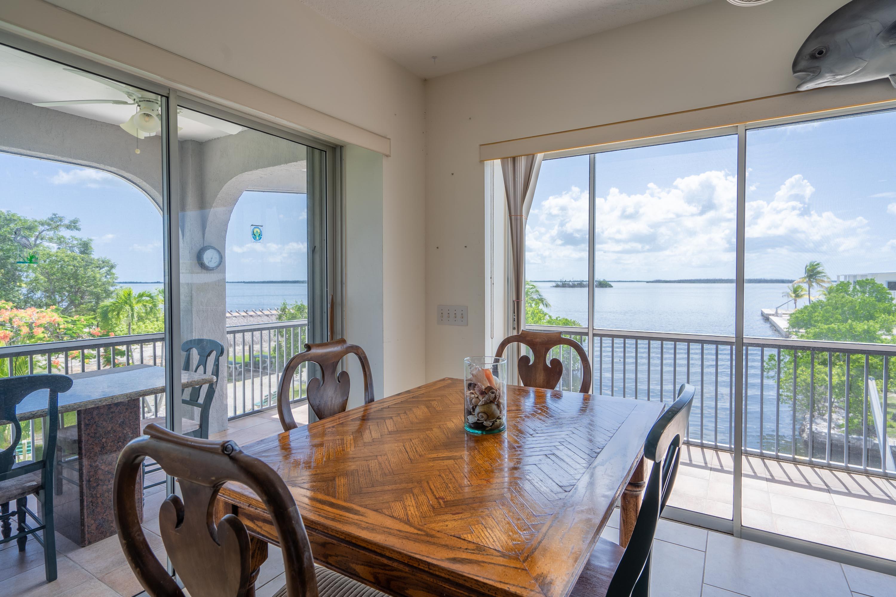 3814 Joyce Road Big Pine Key, FL 33043 - Photo 9 of 40 a view of a dining room with furniture window and outside view