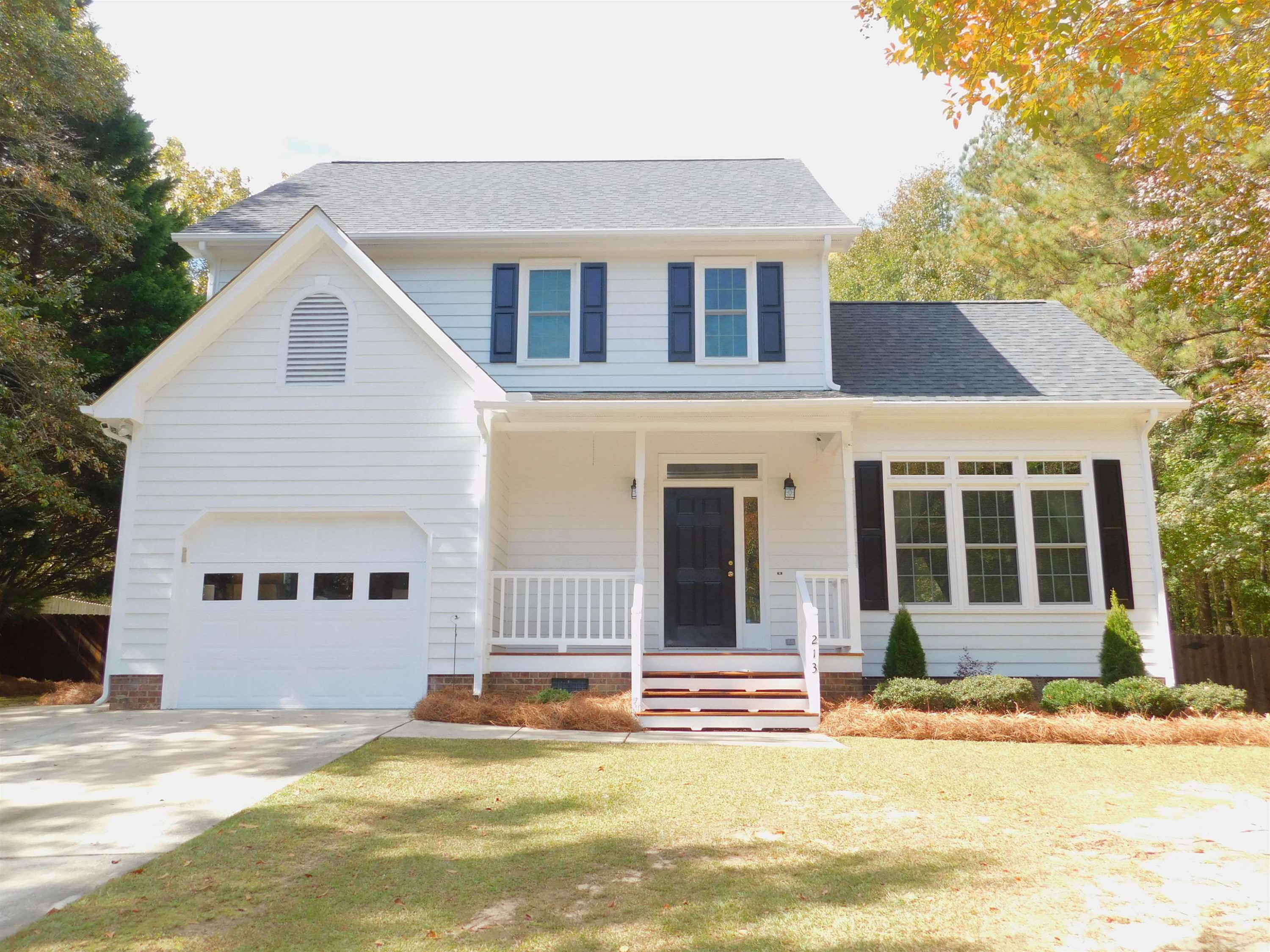 213 Goldfield Drive Garner, NC 27529 - Photo 1 of 18 a view of a white house with a swimming pool