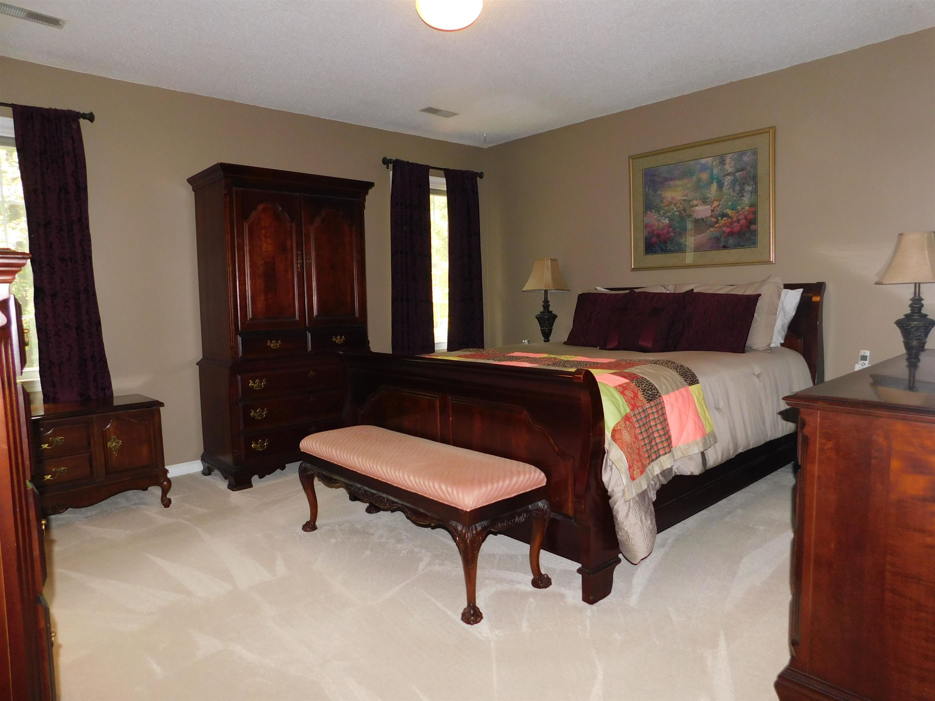 213 Goldfield Drive Garner, NC 27529 - Photo 12 of 18 a bedroom with a bed and a dresser