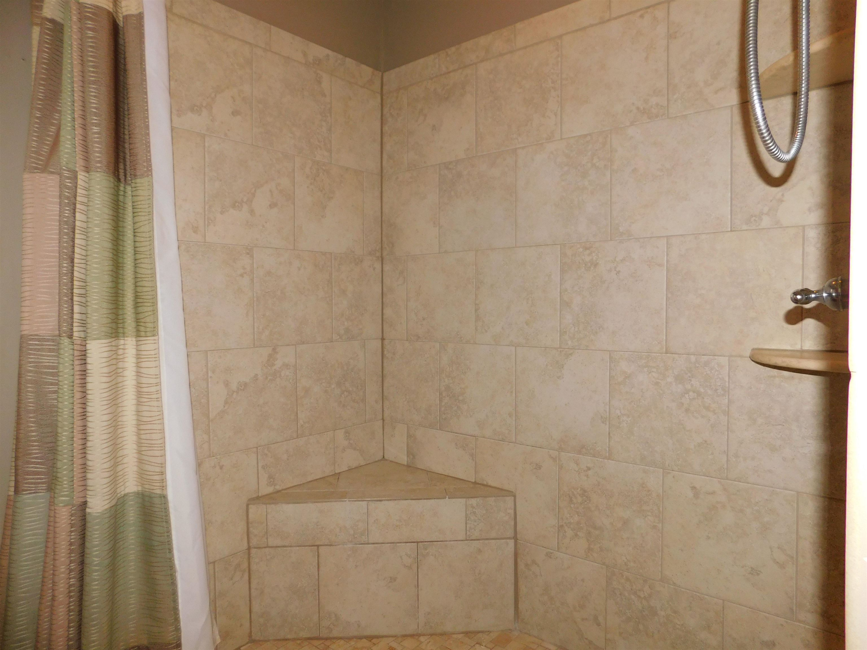 213 Goldfield Drive Garner, NC 27529 - Photo 15 of 18 a bathroom with a glass shower door
