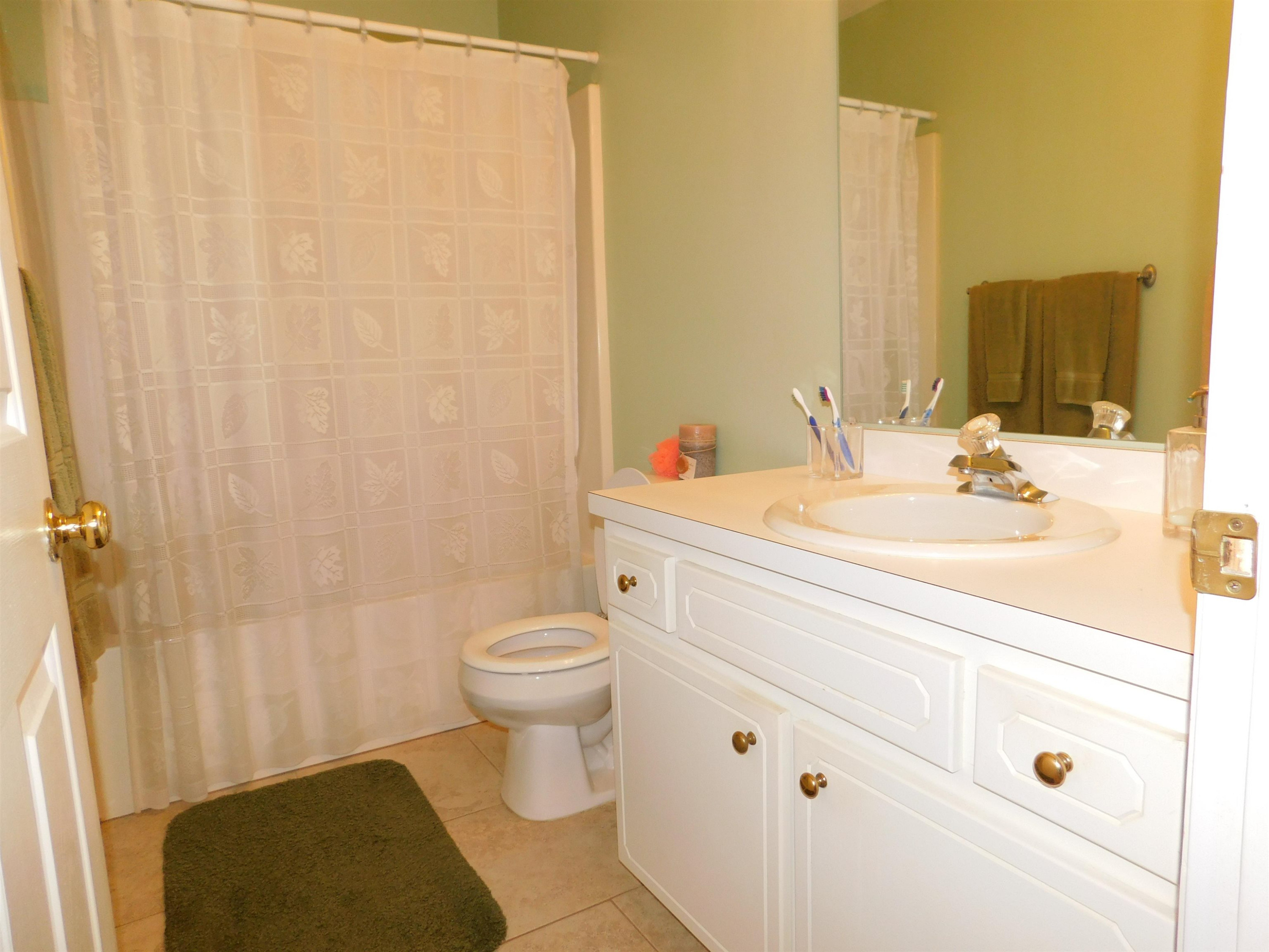 213 Goldfield Drive Garner, NC 27529 - Photo 17 of 18 a bathroom with a sink a toilet and shower