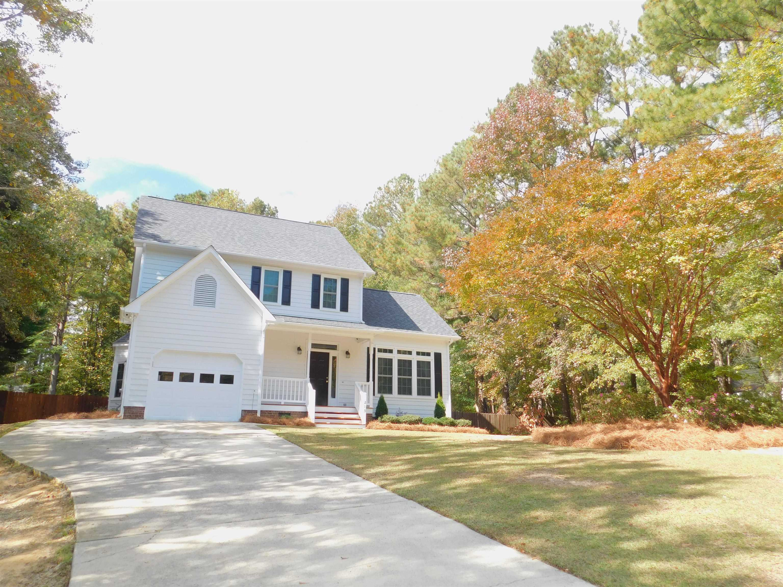 213 Goldfield Drive Garner, NC 27529 - Photo 3 of 18 a front view of a house with a garden