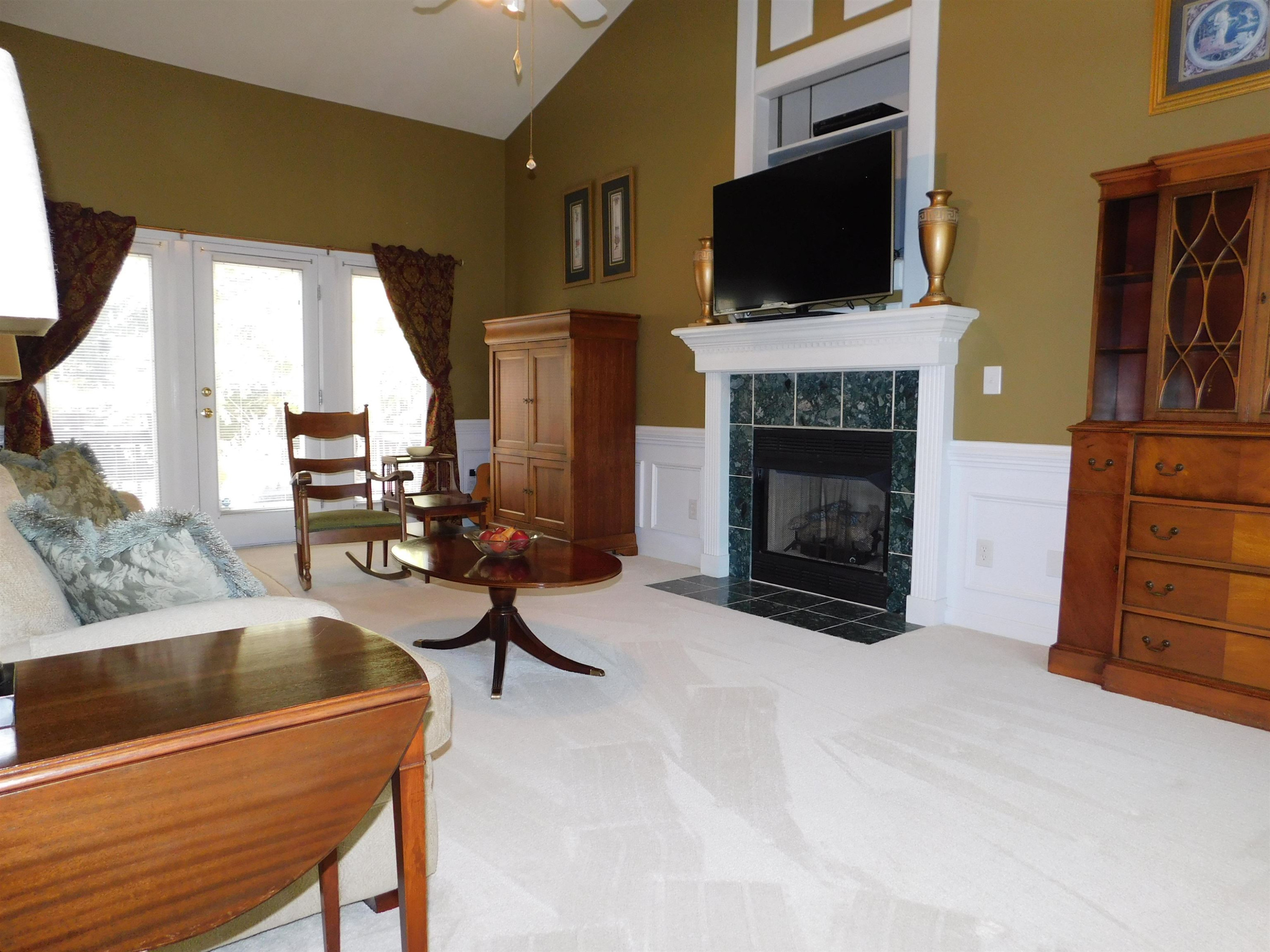 213 Goldfield Drive Garner, NC 27529 - Photo 6 of 18 a living room with furniture a flat screen tv and a fireplace