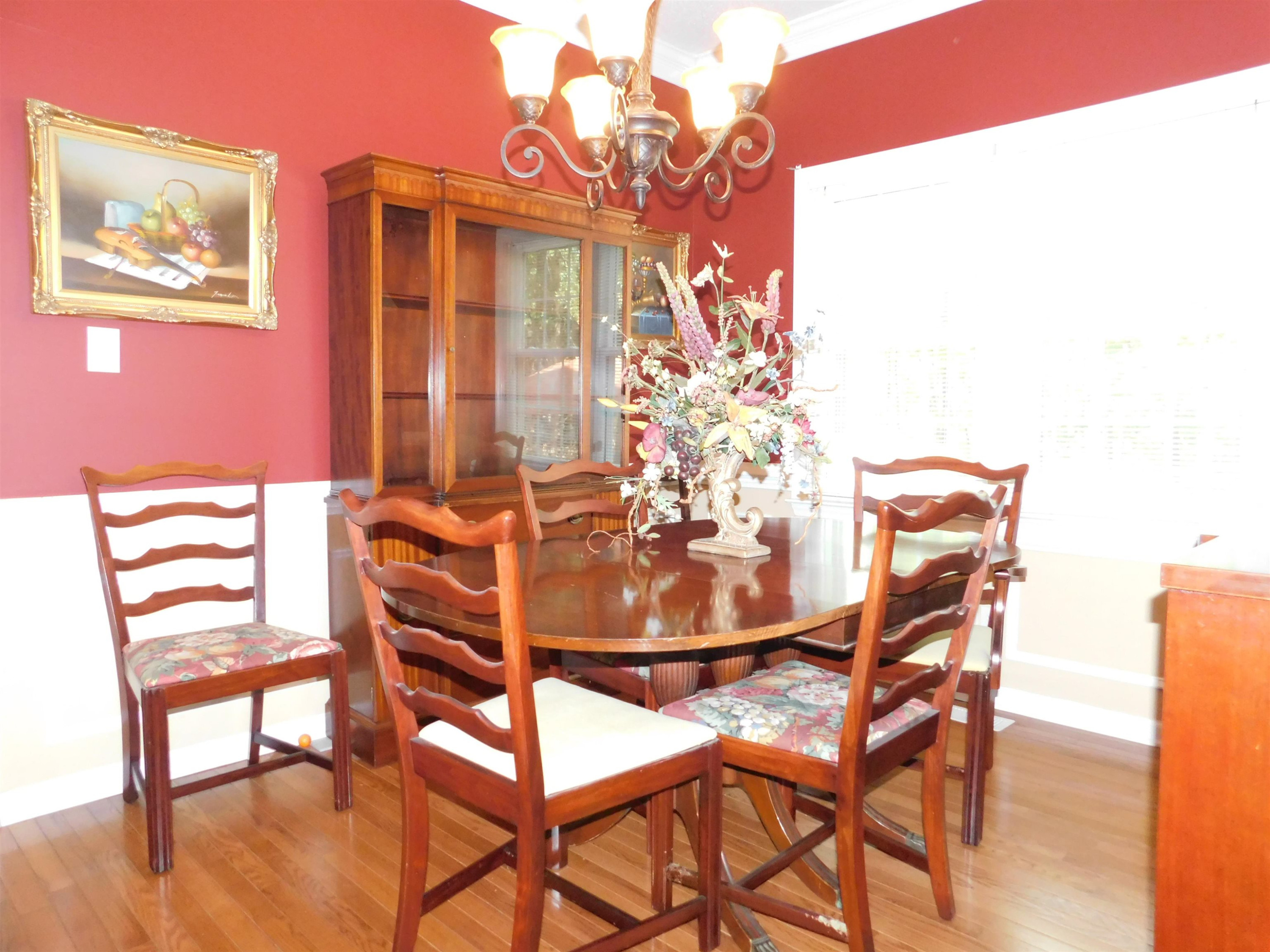 213 Goldfield Drive Garner, NC 27529 - Photo 8 of 18 a view of a dining room with furniture and wooden floor