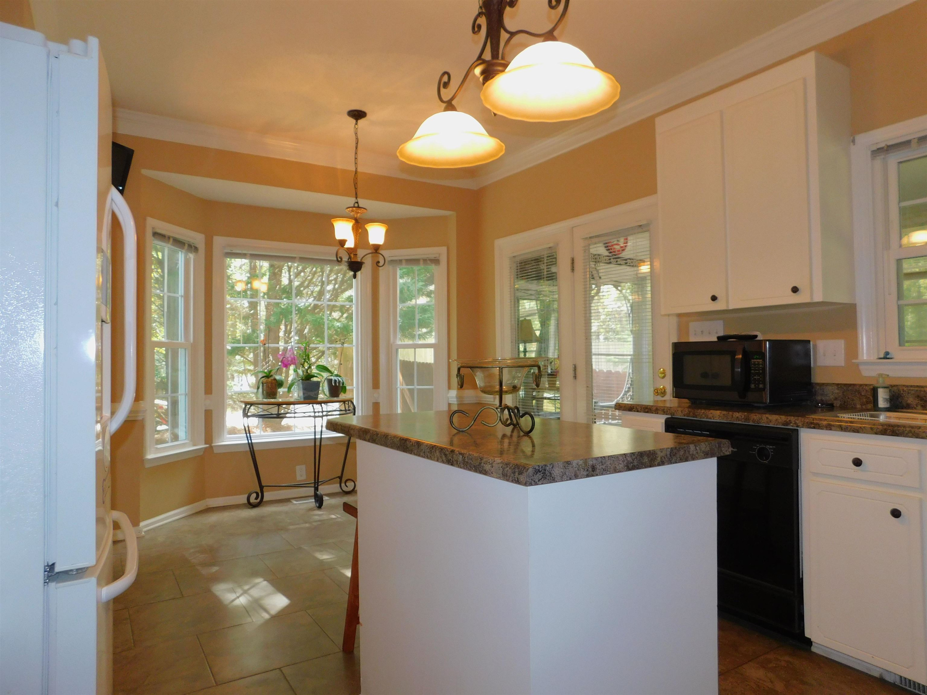 213 Goldfield Drive Garner, NC 27529 - Photo 9 of 18 a kitchen with sink refrigerator and large window
