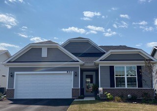 2810 Spring Circle South Lindenhurst, IL 60046 - Photo 1 of 15 a front view of a house with garden