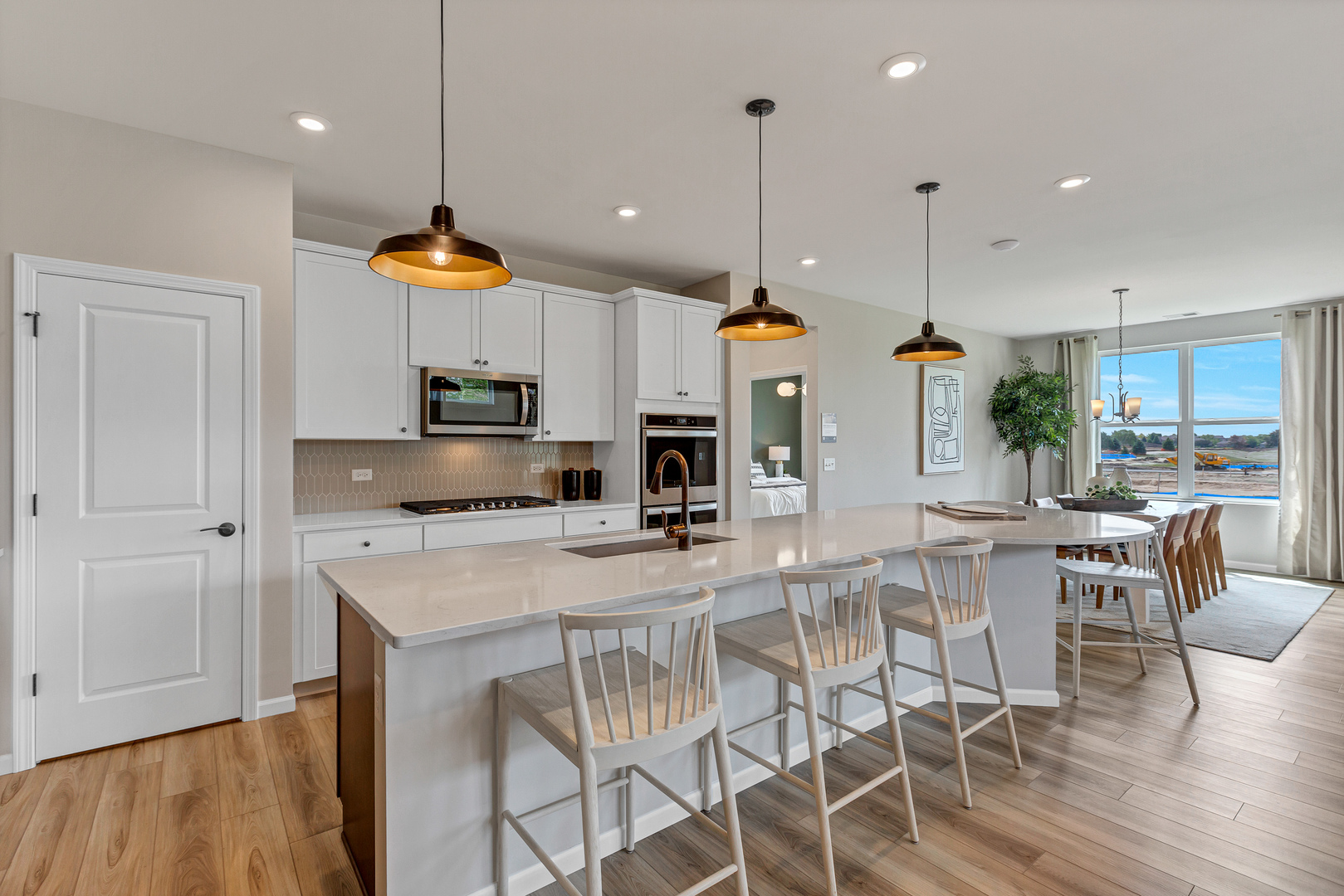 2810 Spring Circle South Lindenhurst, IL 60046 - Photo 4 of 15 a kitchen with stainless steel appliances kitchen island granite countertop a table chairs and a view of living room