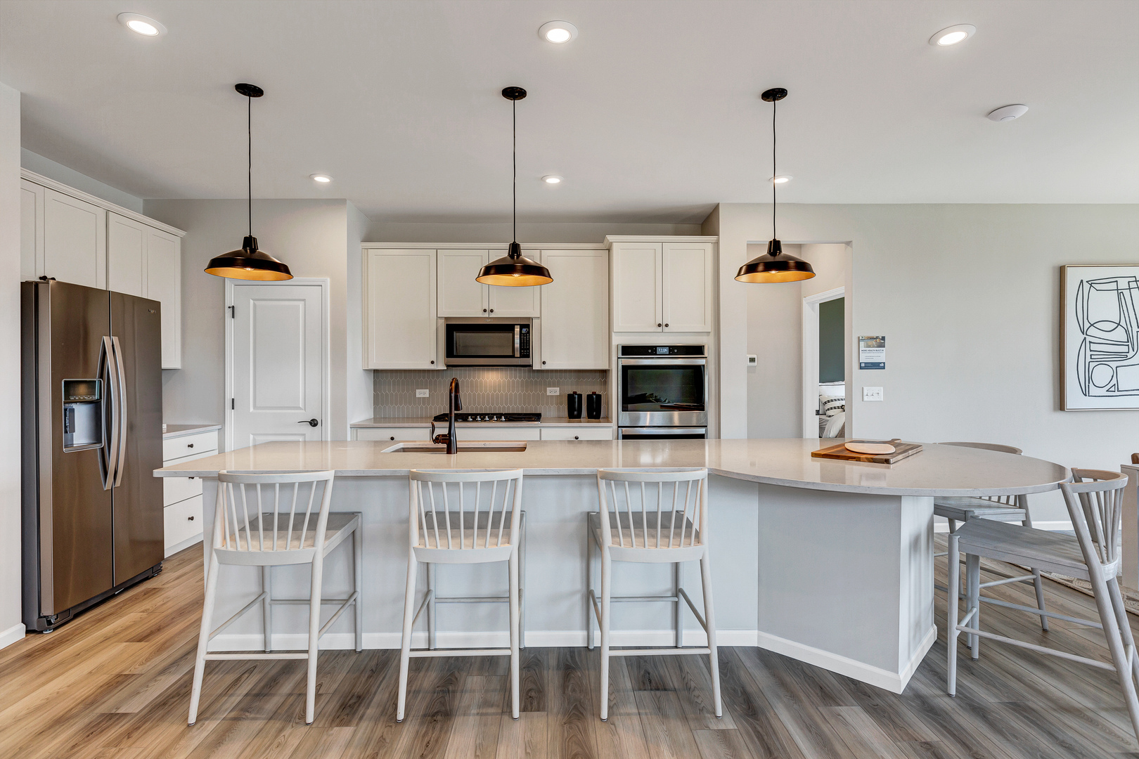 2810 Spring Circle South Lindenhurst, IL 60046 - Photo 5 of 15 a kitchen with stainless steel appliances kitchen island granite countertop a table chairs and a wooden floor