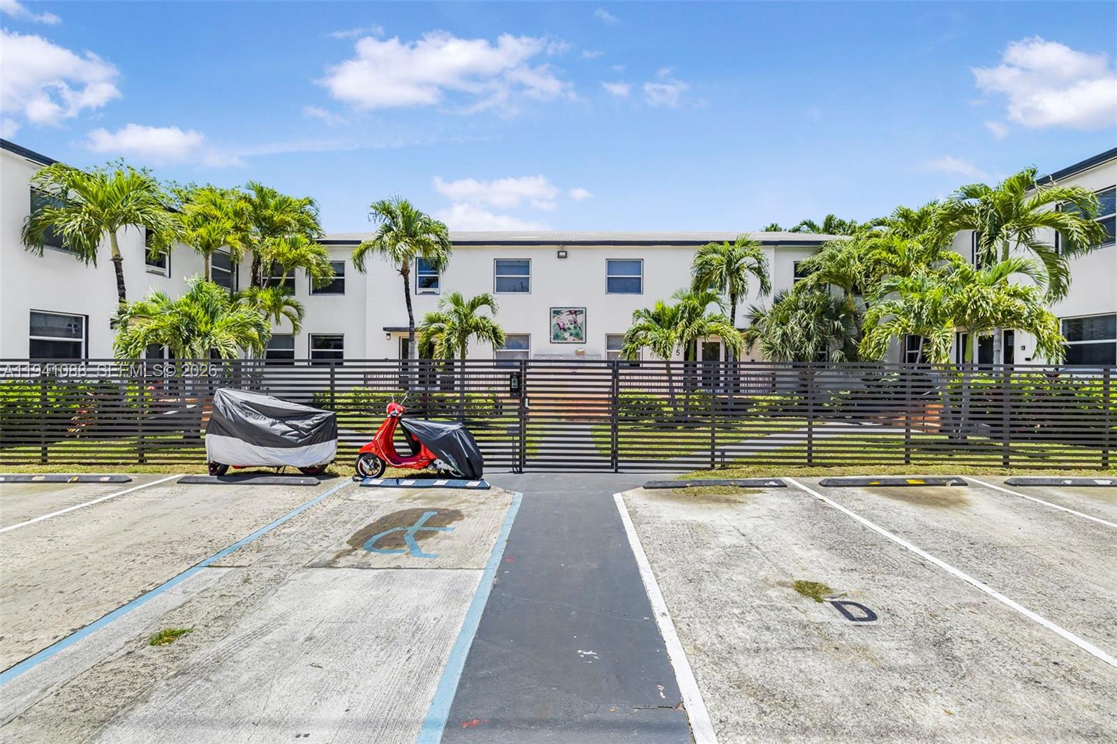 575 Northeast 82nd Street, Unit 10 Miami, FL 33138 - Photo 2 of 14 a view of swimming pool with lounge chair and dinning table under an umbrella