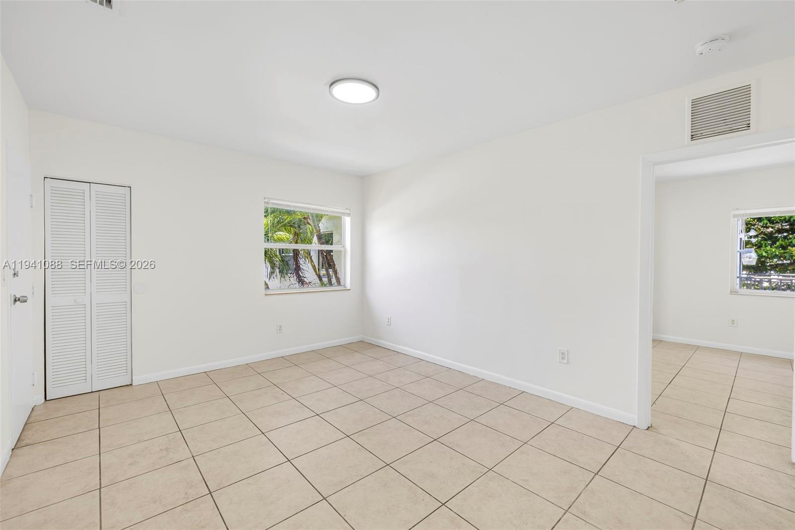 575 Northeast 82nd Street, Unit 10 Miami, FL 33138 - Photo 4 of 14 an empty room with windows