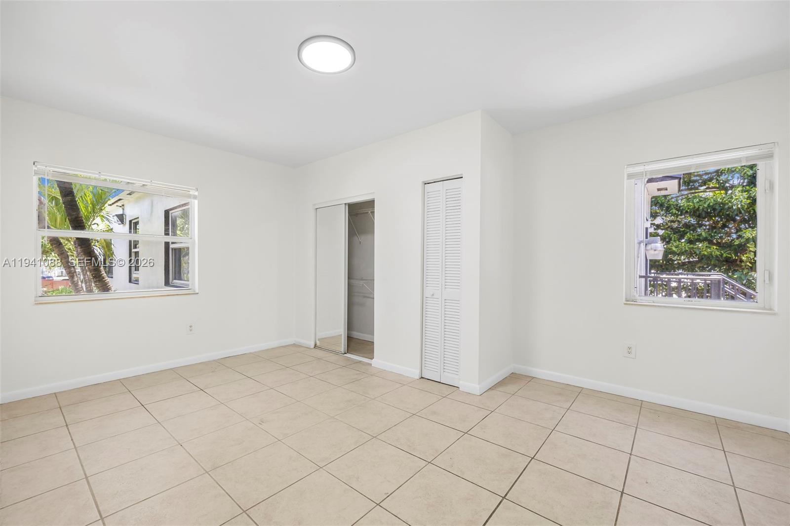 575 Northeast 82nd Street, Unit 10 Miami, FL 33138 - Photo 10 of 14 a view of an empty room with window and cabinet