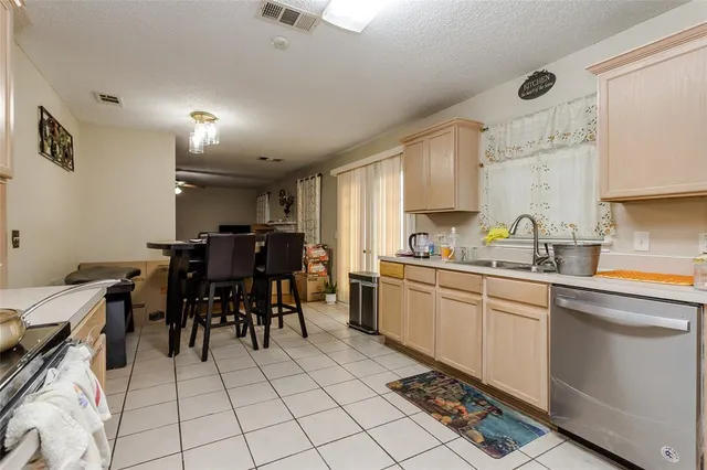 a kitchen with a dining table chairs and white appliances