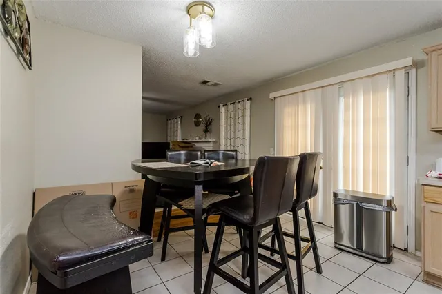 a view of a dining room with furniture and window