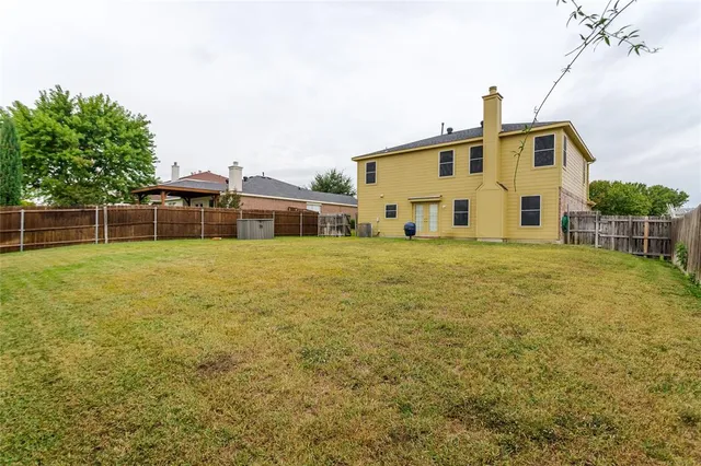 a view of a house with a yard and sitting area