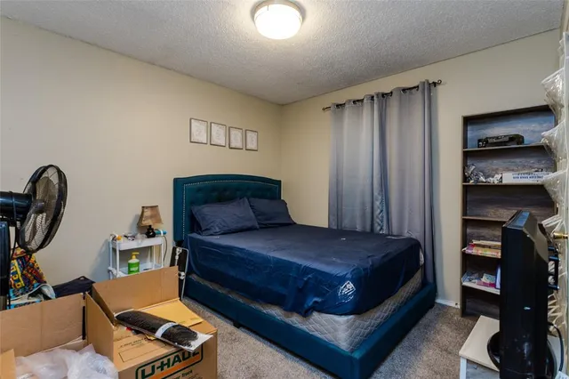 a bedroom with a bed and a bookshelf