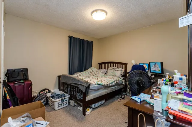 a bedroom with furniture and a fan
