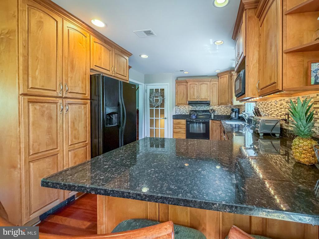 925 Big Oak Road Yardley, PA 19067 - Photo 19 of 51 a kitchen with stainless steel appliances granite countertop a refrigerator a stove and a sink with granite countertops