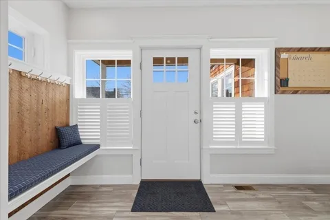 a view of a bedroom with wooden floor and a window