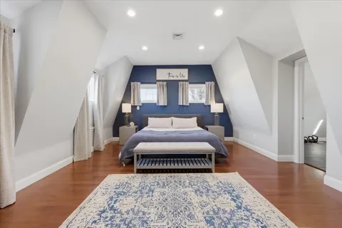 a bedroom with a bed and a rug
