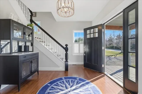a view of entryway and hall with wooden floor