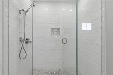 a bathroom with a shower sink and mirror