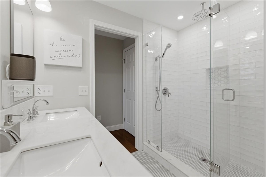 27 Curtis Street Scituate, MA 02066 - Photo 22 of 40 a bathroom with a shower sink and mirror