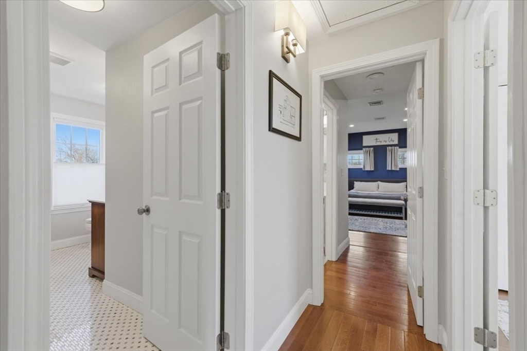 27 Curtis Street Scituate, MA 02066 - Photo 23 of 40 a view of a hallway with wooden floor and windows in a room