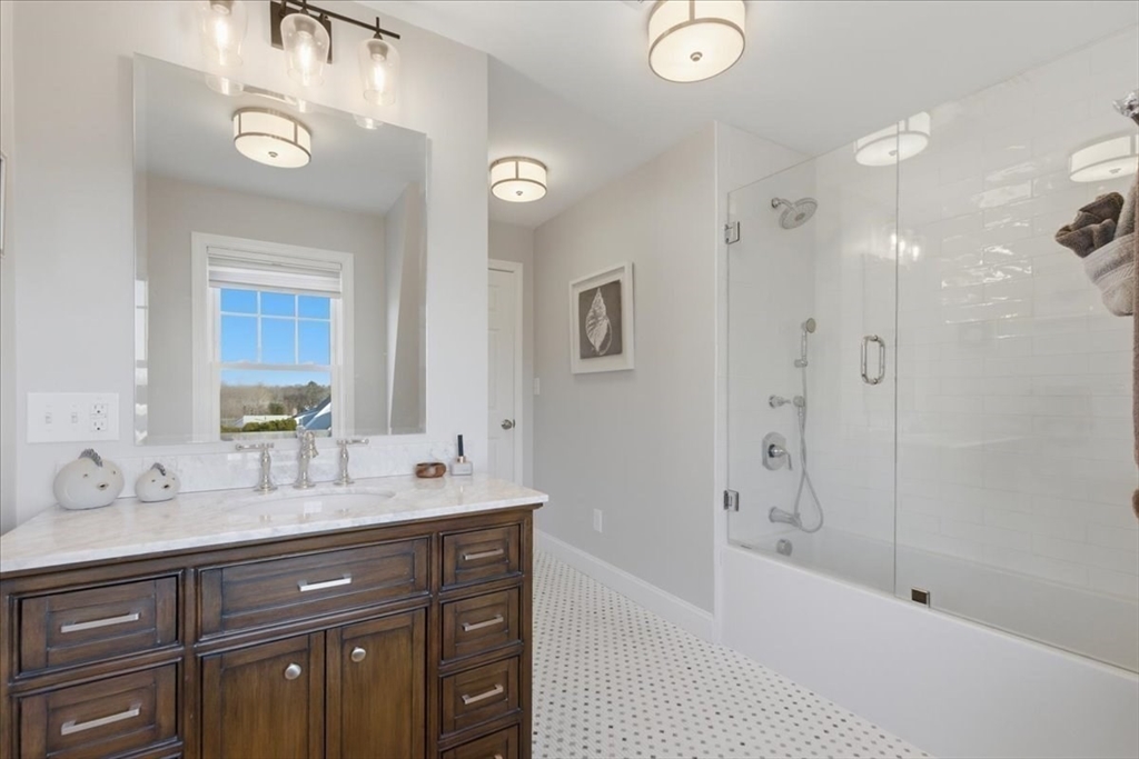 27 Curtis Street Scituate, MA 02066 - Photo 24 of 40 a bathroom with a tub sink double vanity and mirror