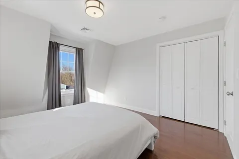 a bedroom with a bed and a painting on the wall
