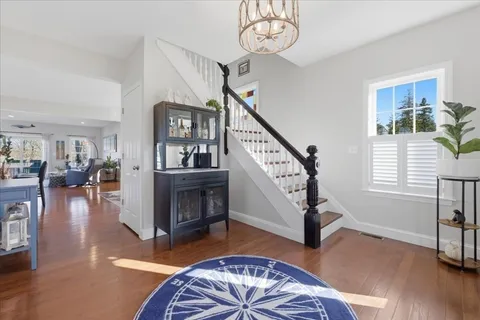 a view of a livingroom with furniture and hardwood floor