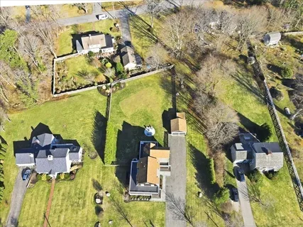 a view of a brick house with large windows and a table and chairs
