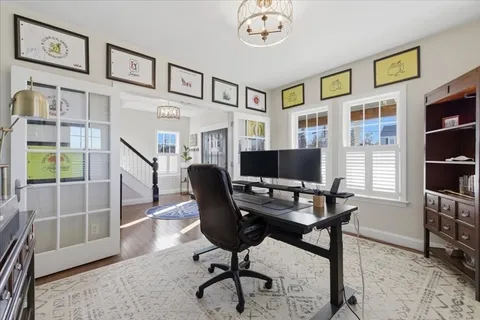 a view of a livingroom with furniture and a bookshelf