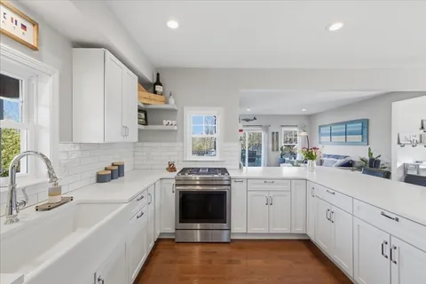 a kitchen with a sink stove and cabinets